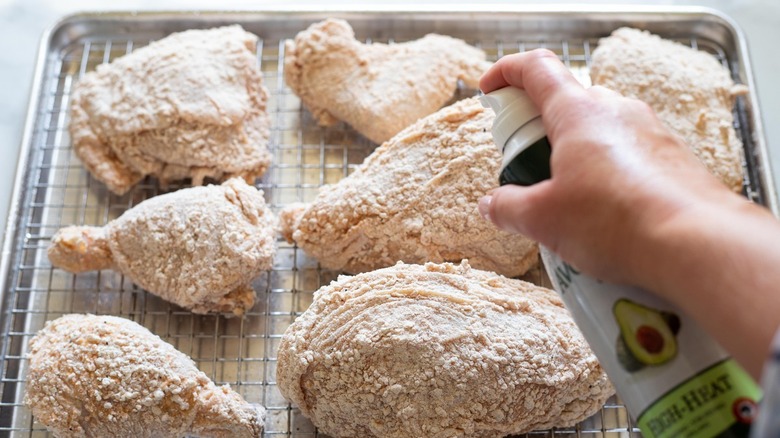 spraying chicken on rack