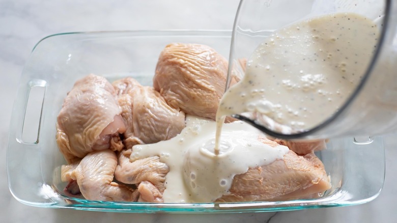 buttermilk marinade pouring over chicken