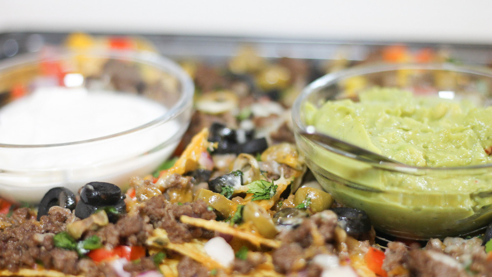 finished sheet pan nachos with condiments