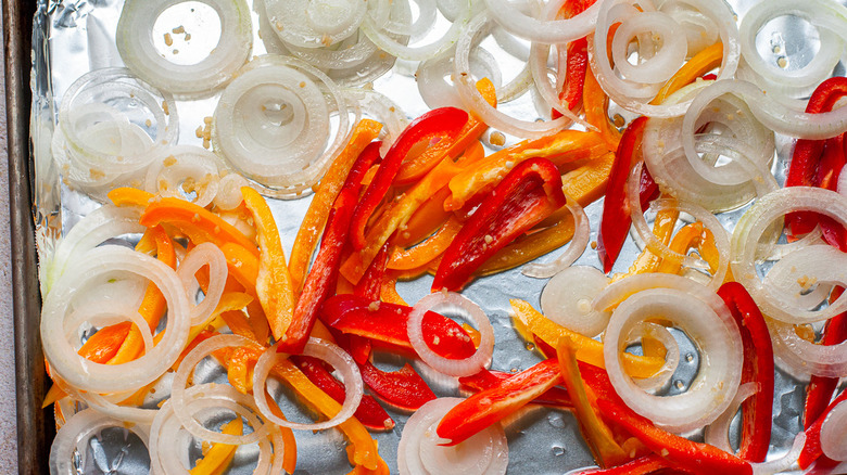 onions and peppers on pan 