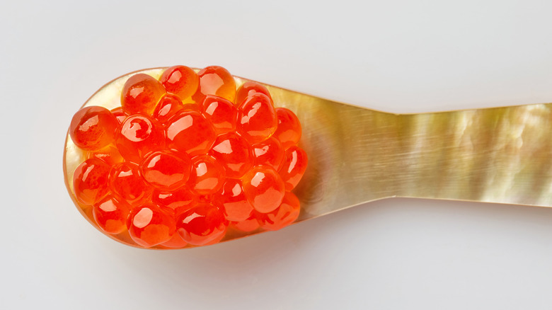 orange roe on a mother of pearl spoon