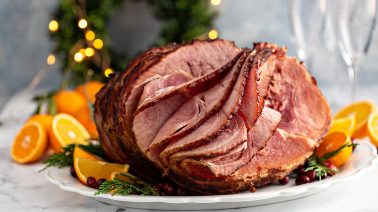 Spiral-cut ham on a platter with oranges