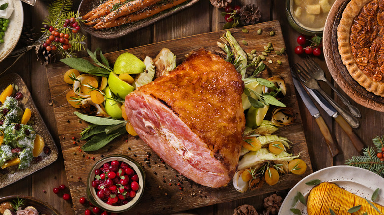 overhead shot of a glazed Christmas ham on a festive table