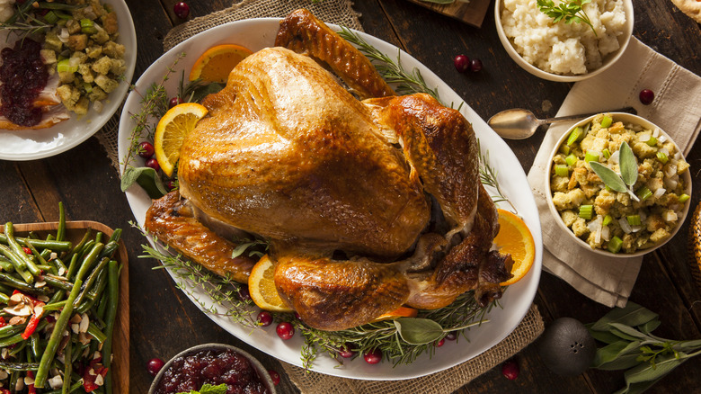 Thanksgiving turkey with sides on wooden table