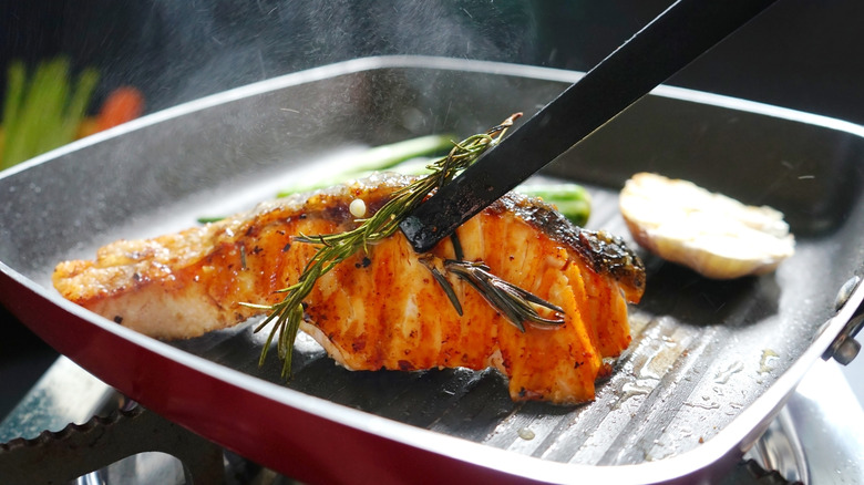 Grilling salmon in a pan