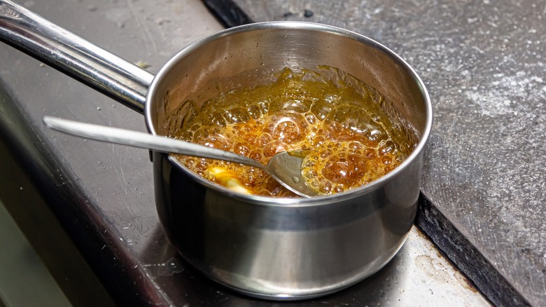 Pot of bubbling caramel sauce