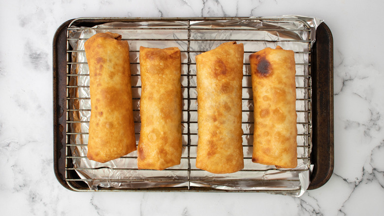 fried chimichangas on wire rack