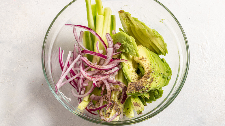 Bowl with julienned cucumber, avocado, and red onion