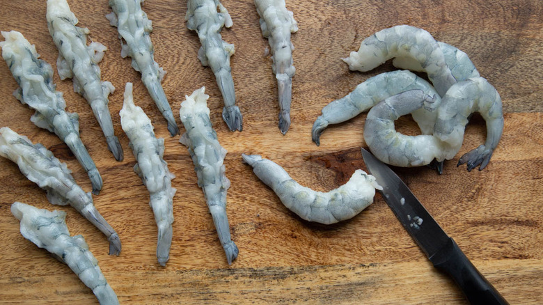 deveining shrimp on cutting board