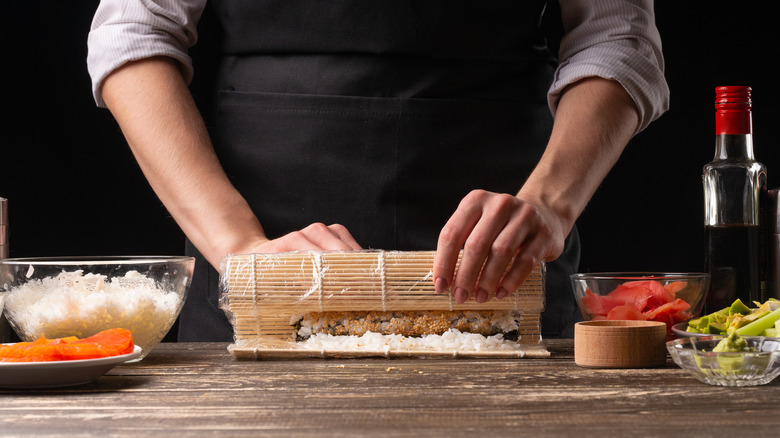 Chef making a sushi roll