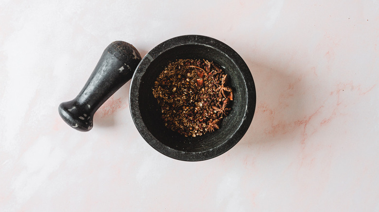 whole spices in mortar and pestle