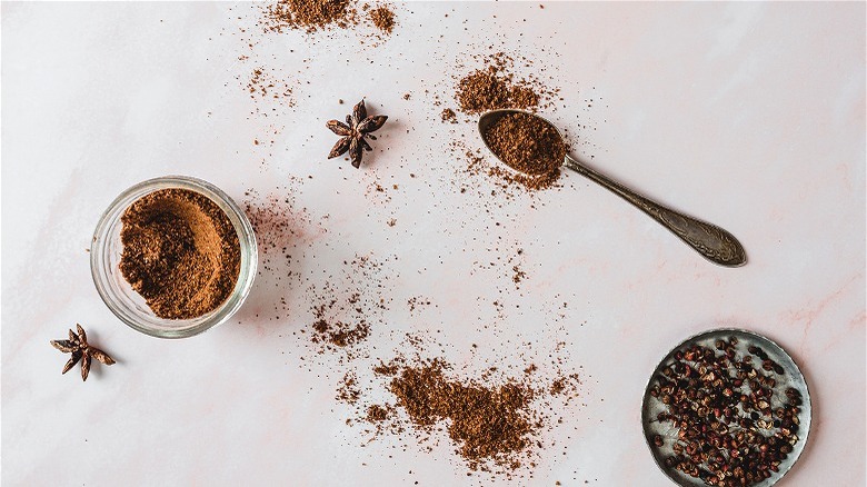 ground spices in jar and spoon