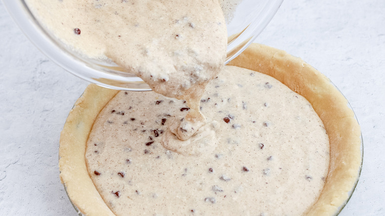 adding filling to pie crust