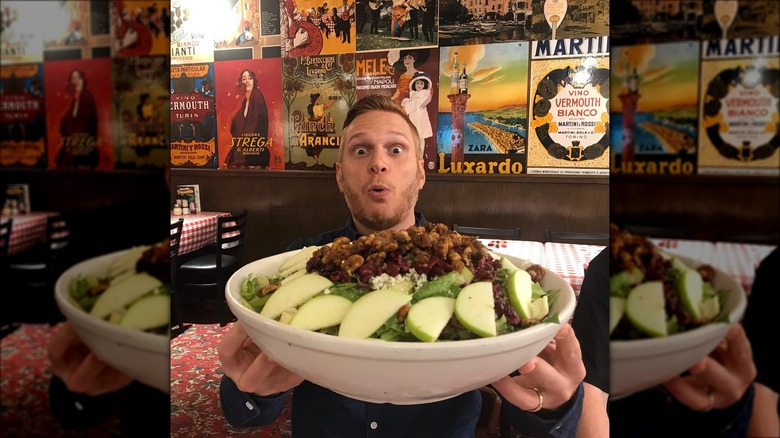 man receiving huge salad