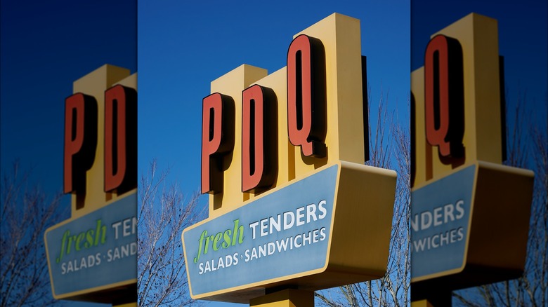 PDQ sign against a blue sky