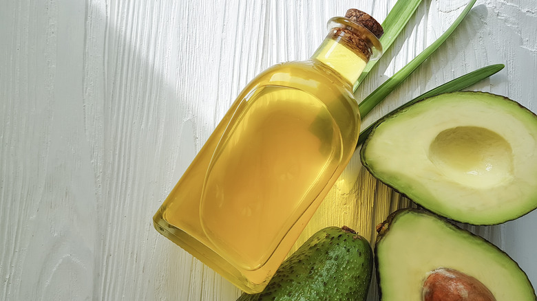 bottle of oil with avocados