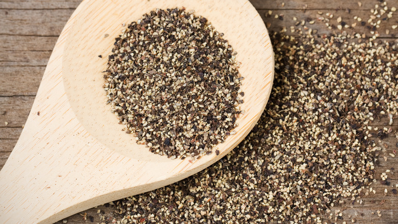 ground black pepper on spoon