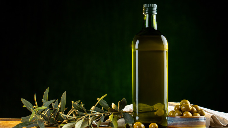 green oil bottle on table