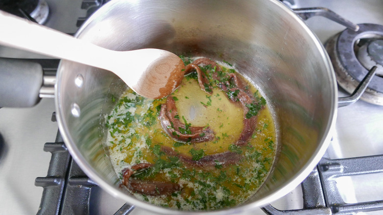 butter and anchovies in saucepan 