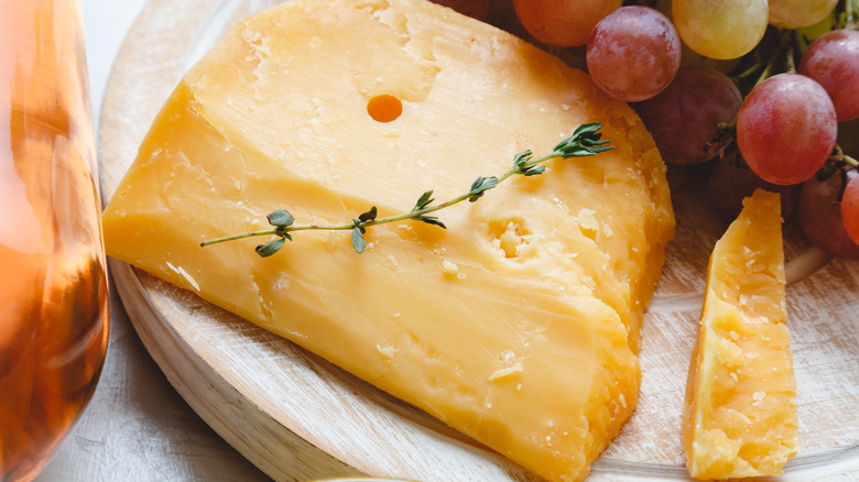 sliced, crumbly cheddar on cheeseboard