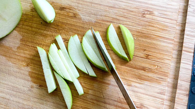 knife slicing apple