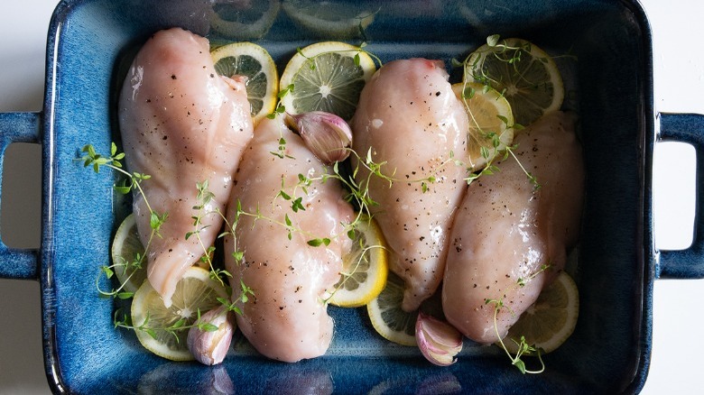 seasoned raw chicken in roasting pan