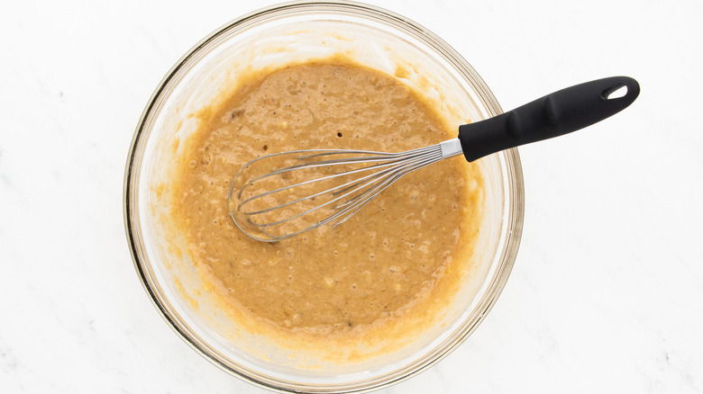 Muffin batter in mixing bowl with whisk