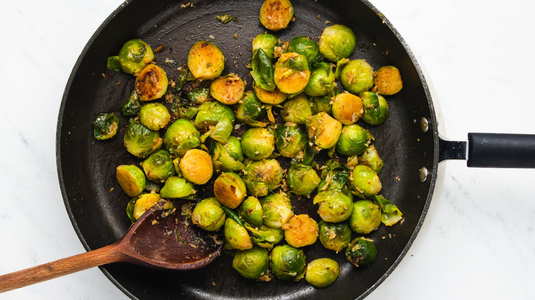 Brussels sprouts frying in pan