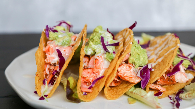 brightly colored fish tacos in a crunchy shell plated