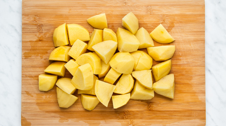 chopped potatoes on cutting board