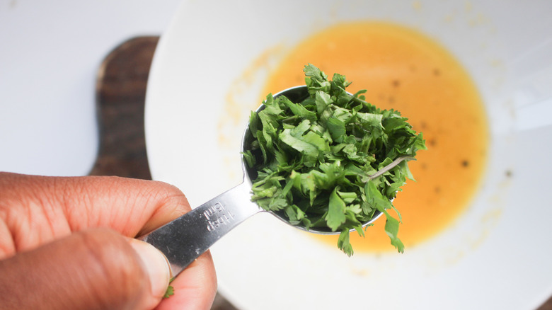 Adding parsley to melted butter