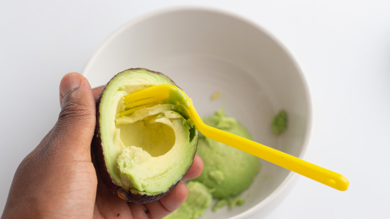 scooping out avocado