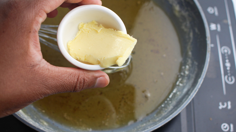 butter going into a pan 