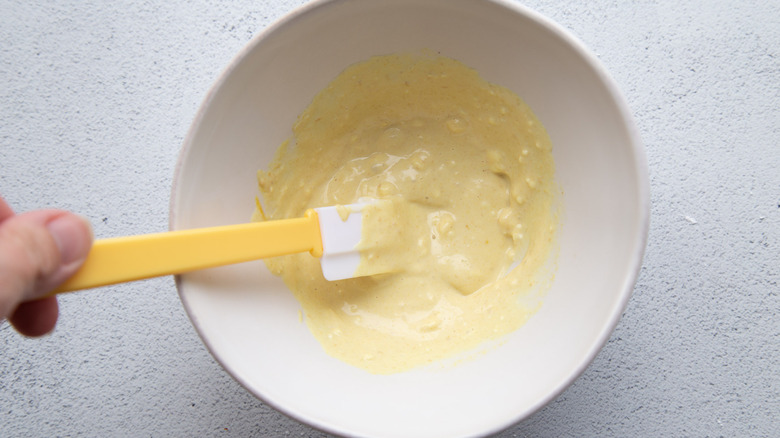 yellow sauce in bowl with spatula