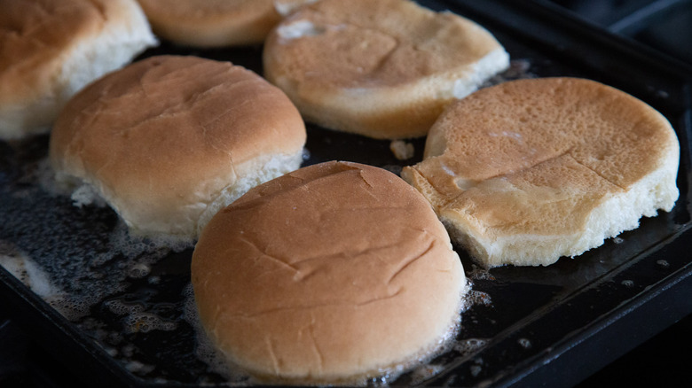 burger buns on a griddle 