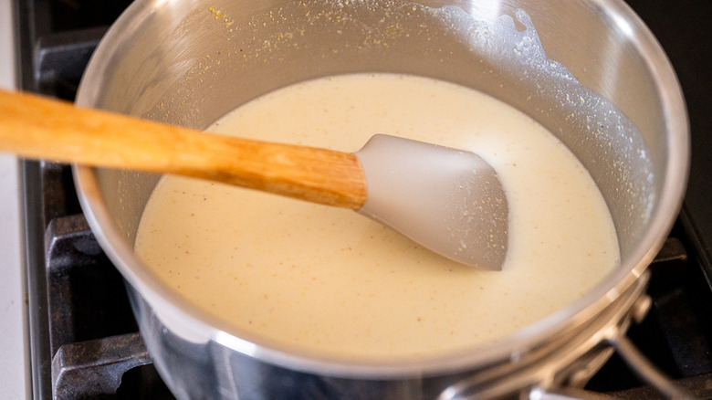 stirring cornmeal milk mixture