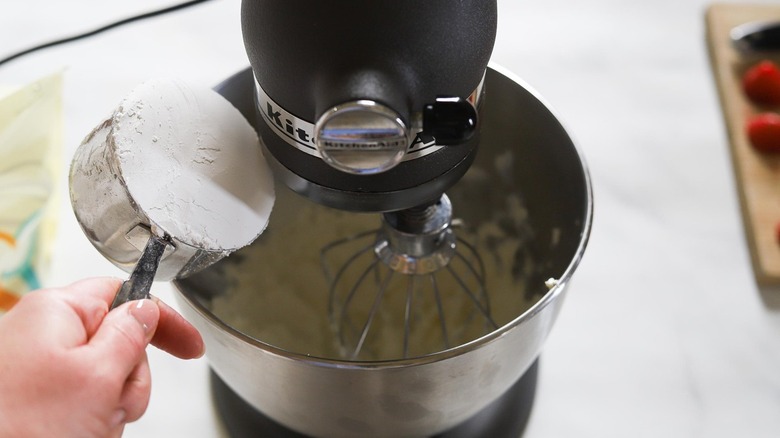 pouring sugar into mixer