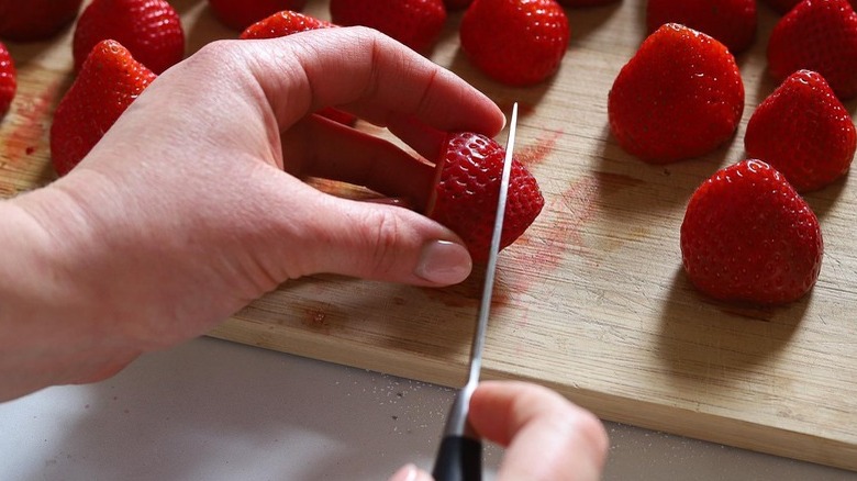 hand slicing strawberries