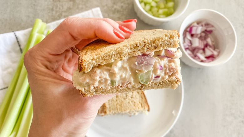 tuna salad sandwich in hand