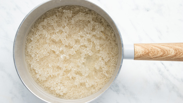 rice and water in saucepan