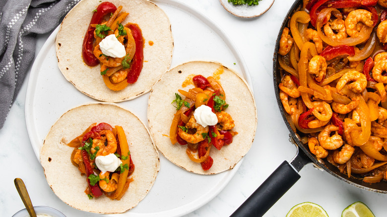 Shrimp fajitas on plate and in pan