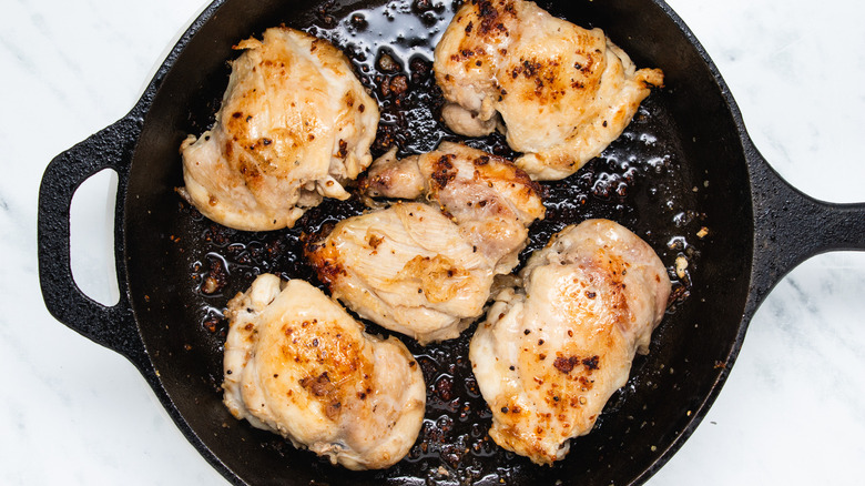 chicken thighs browning in pan