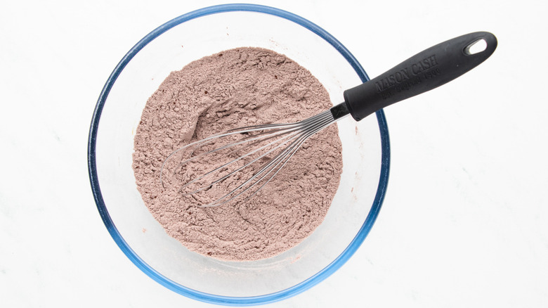 Whisking flour cocoa powder mixture in bowl