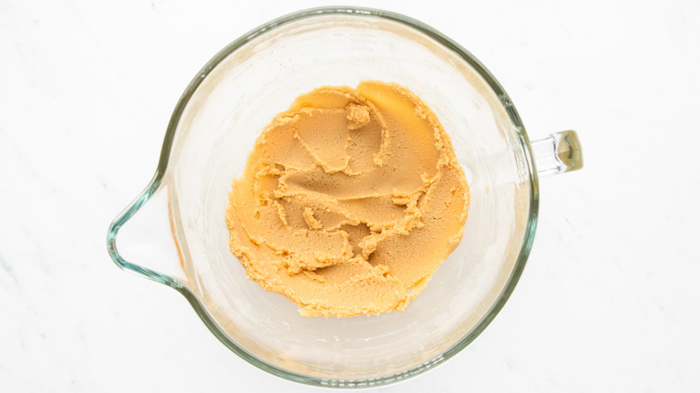 Butter and sugar mixture in glass mixing bowl