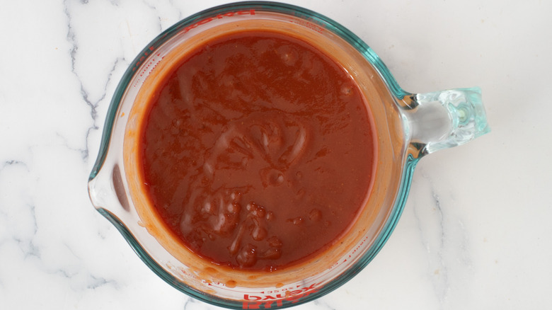 red sauce in measuring cup