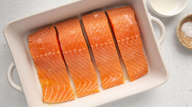 raw salmon in white pan