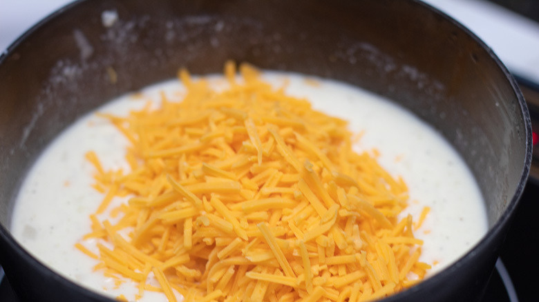 Slow Cooker Au Gratin Potatoes - cheese ready to be mixed into the sauce