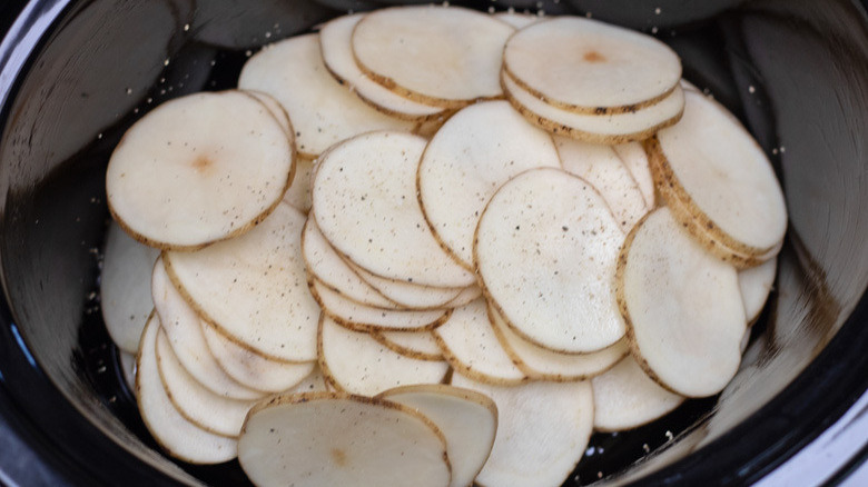 Slow Cooker Au Gratin Potatoes - potato slices stacked