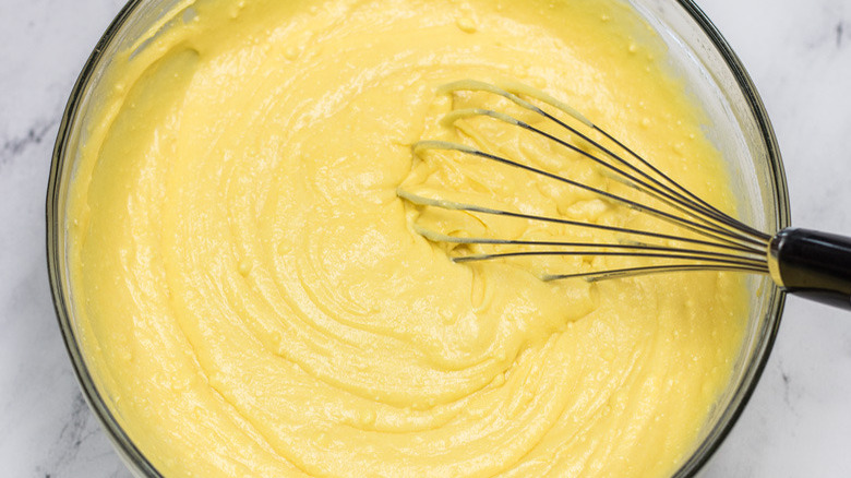 banana pudding cake batter mix in bowl with whisk