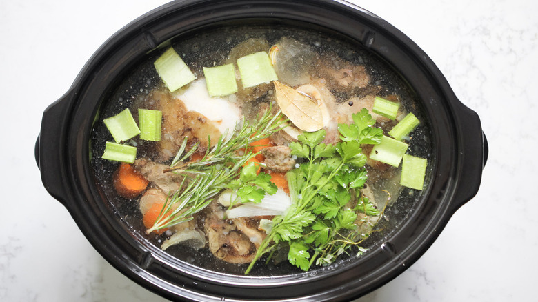 beef, herbs, vegetables in slow cooker